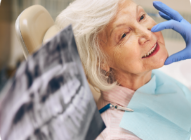 portrait-smiling-female-patient-sitting-dental-chair-while-woman-doctor-touching-face-client