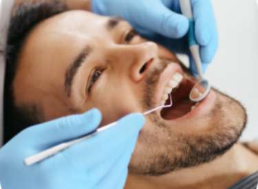 smiling-young-man-sitting-dentist-chair-while-doctor-examining-his-teeth-1